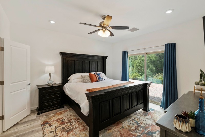 Primary bedroom with forest slider view